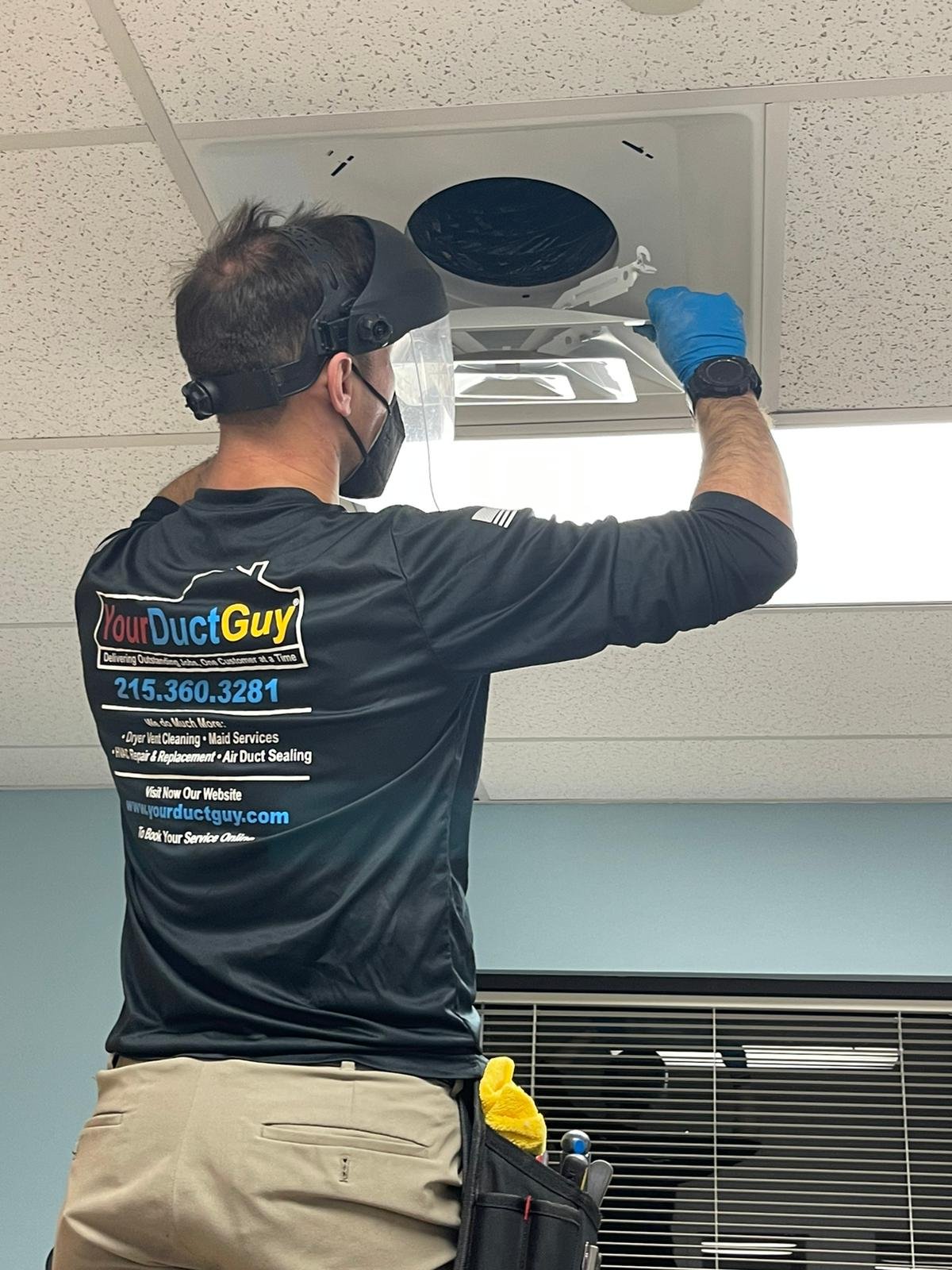 Technician holding a dirty commercial vent cover