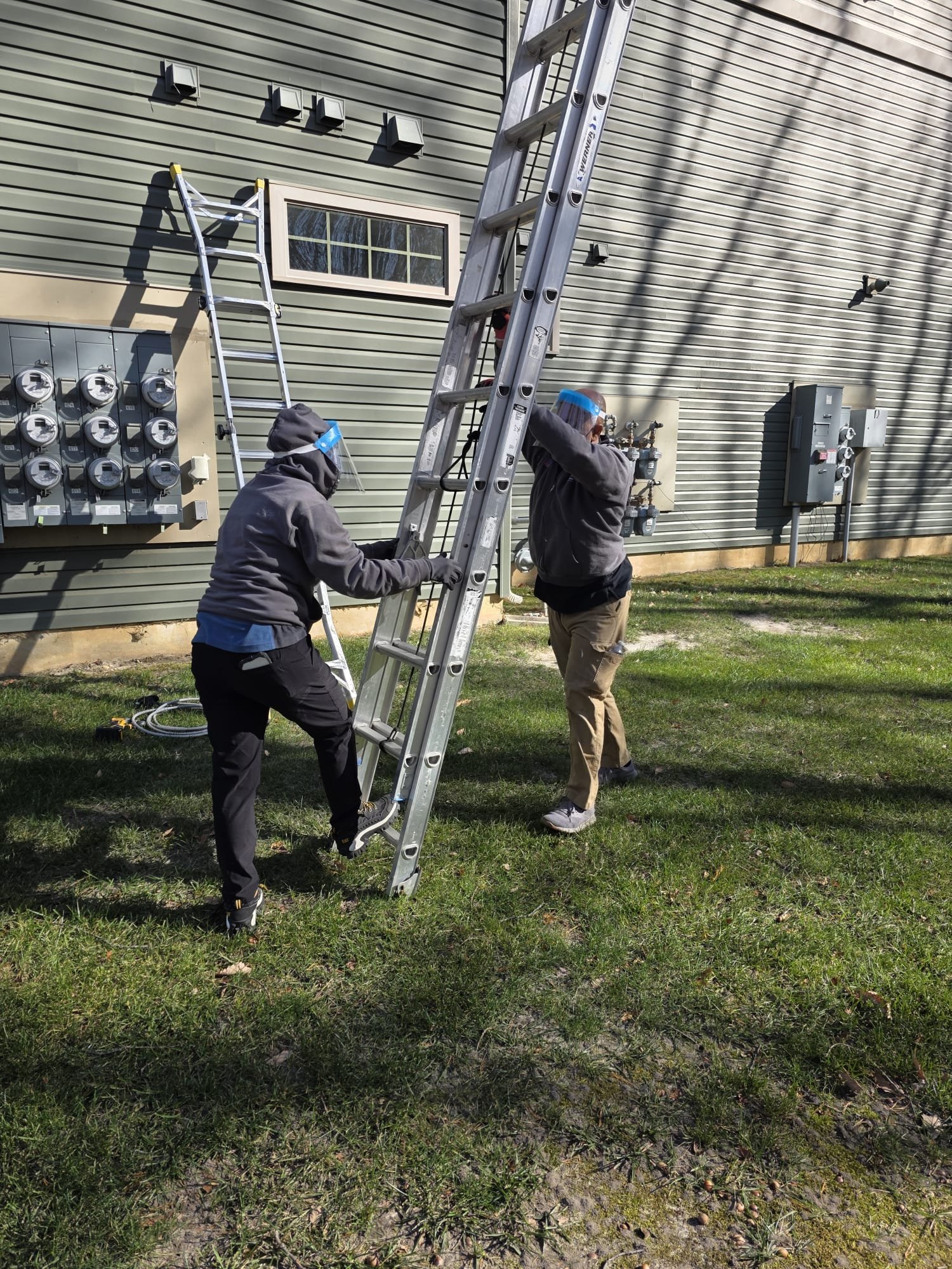 Our crew setting ladders for a condominium dryer vent cleanout