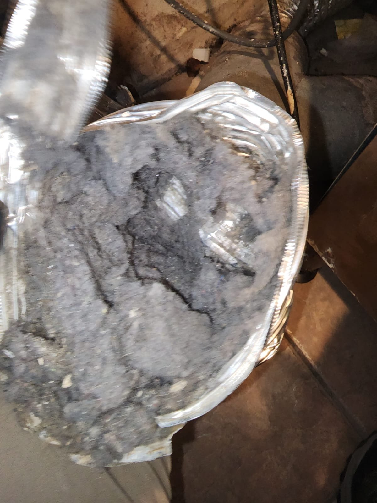 Close-up of lint packed inside a dryer vent