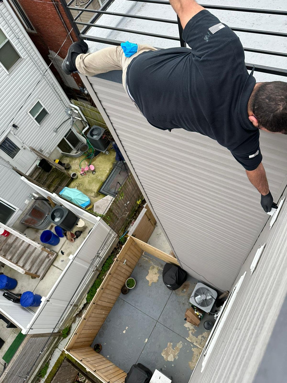 Technician reaching a high dryer vent on a home