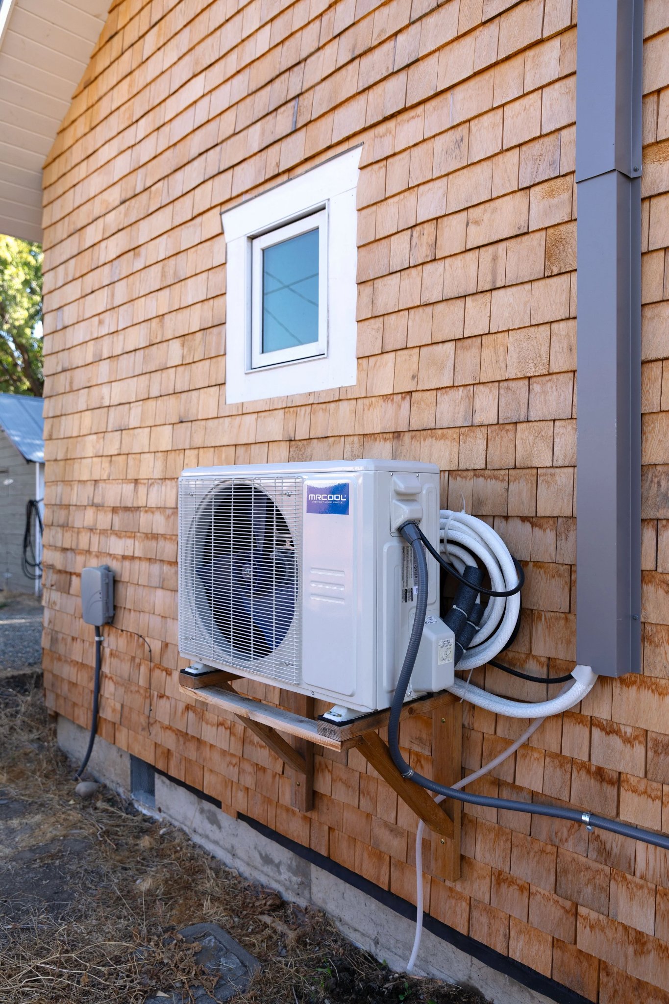 MRCOOL mini-split wall-mounted on shingle siding