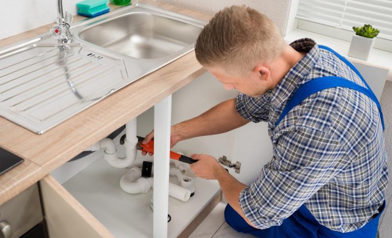 Plumber repairing a sink drain